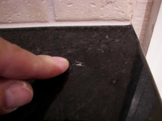 Chipped Granite Repaired Before Small chip in the countertop, before repair